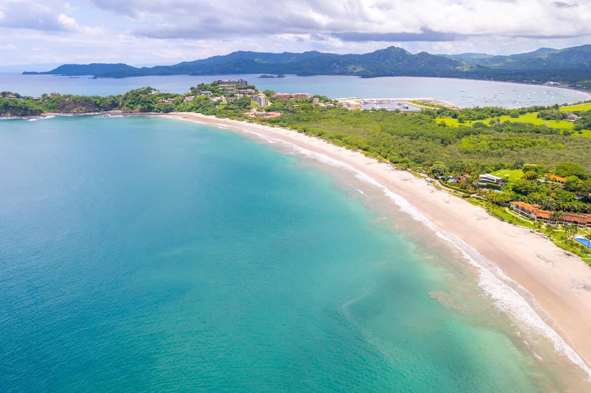 Aerial view of Playa Flamingo beach with turquoise water and coastal hills in Guanacaste Costa Rica