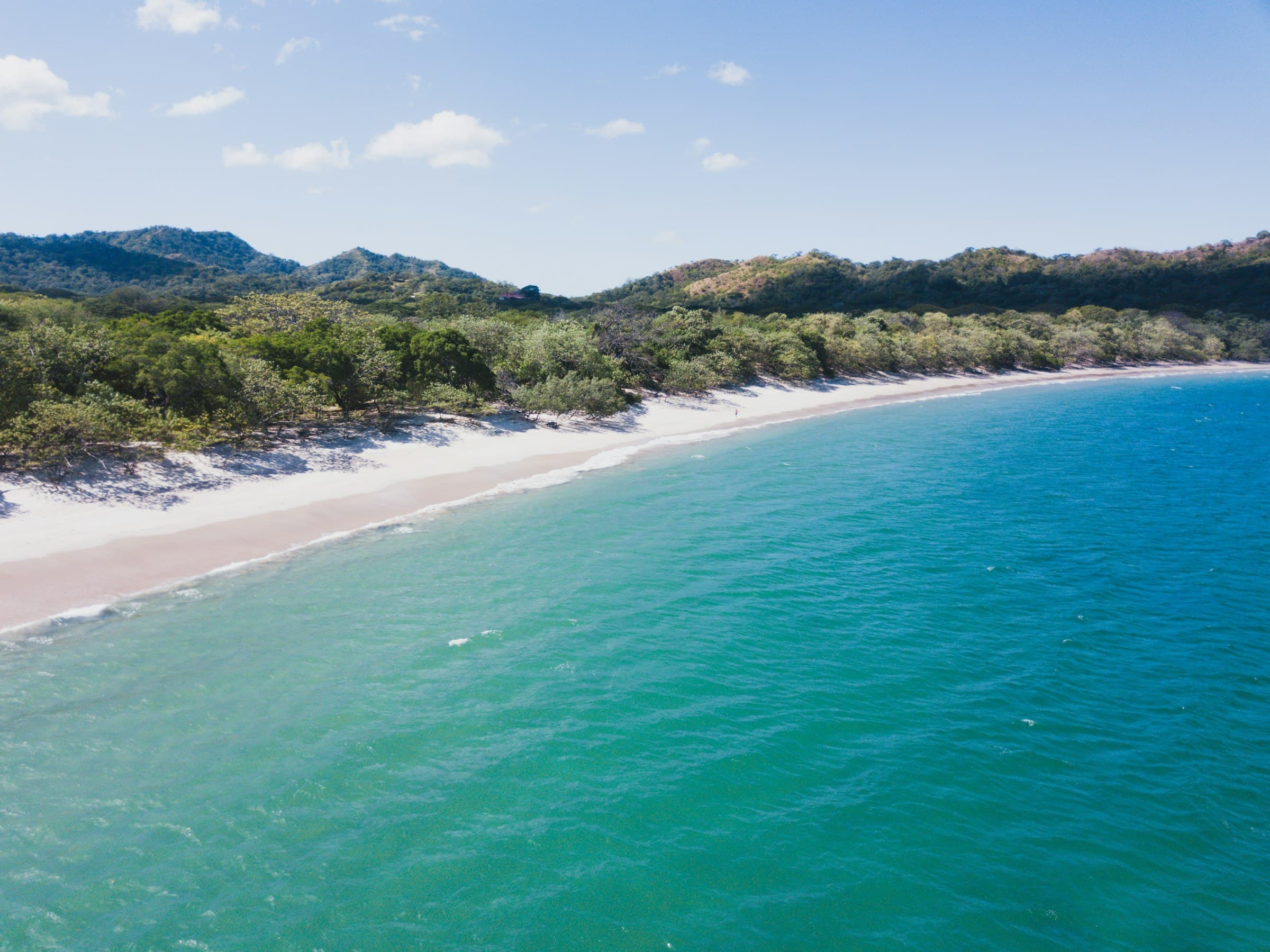 Aerial view of Playa Conchal in Guanacaste Costa Rica with turquoise water, coastline, and coastal hills